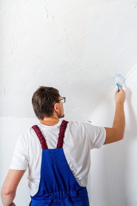 man-in-blue-overall-painting-wall-with-paintbrush-2022-04-09-20-30-30-utc